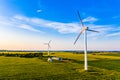 Beautiful landscape in countryside. Electricity generation in rural area. Wind turbines in field Royalty Free Stock Photo