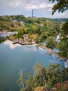 Beautiful landscape: dam, waterfall, trees, skyblue river houses monument nature