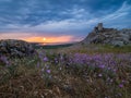 Beautiful landscape and a dramatic sunset sky with storm clouds over Enisala old stronghold citadel Royalty Free Stock Photo