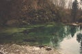 Emerald pool among hill reflect green tree and forest