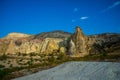 Beautiful landscape with fabulous mountain-like rocks and houses and churches near from the village of Cavusin. Cappadocia, Turkey Royalty Free Stock Photo