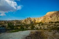 Beautiful landscape with fabulous mountain-like rocks and houses and churches near from the village of Cavusin. Cappadocia, Turkey Royalty Free Stock Photo