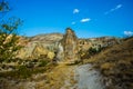 Beautiful landscape with fabulous mountain-like rocks and houses and churches near from the village of Cavusin. Cappadocia, Turkey Royalty Free Stock Photo