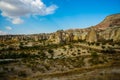 Beautiful landscape with fabulous mountain-like rocks and houses and churches near from the village of Cavusin. Cappadocia, Turkey Royalty Free Stock Photo