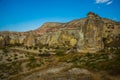 Beautiful landscape with fabulous mountain-like rocks and houses and churches near from the village of Cavusin. Cappadocia, Turkey Royalty Free Stock Photo