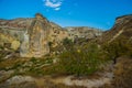 Beautiful landscape with fabulous mountain-like rocks and houses and churches near from the village of Cavusin. Cappadocia, Turkey Royalty Free Stock Photo