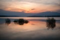 Beautiful landscape with fiery sunset over a lake . View from the coast - Image Royalty Free Stock Photo