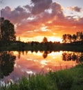 Beautiful landscape with fiery sunset over the lake Royalty Free Stock Photo