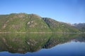 Beautiful landscape in the fjord, with reflections of the mountains in the water. Rosendal, Hardangerfjord, Norway. Royalty Free Stock Photo