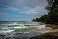 Beautiful landscape with foamy waves washing the sandy beach in Costa Rica Royalty Free Stock Photo