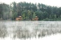 Beautiful landscape with forest and houses near lake. Camping season Royalty Free Stock Photo