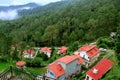 -Beautiful landscape with forest and pines, mountain cottage and fog and low clouds in the mountains. Royalty Free Stock Photo