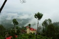 -Beautiful landscape with forest and pines, mountain cottage and fog and low clouds in the mountains. Royalty Free Stock Photo