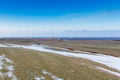 Beautiful landscape in glass green field with clear blue sky during late winter time Royalty Free Stock Photo