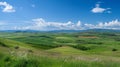 Beautiful landscape of green field, blue sky and white clouds Royalty Free Stock Photo