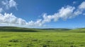 Beautiful landscape of green field, blue sky and white clouds Royalty Free Stock Photo