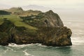 Beautiful landscape of a green field and a cliff