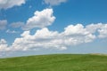 Beautiful landscape. Green grass field and cloudy blue sky Royalty Free Stock Photo