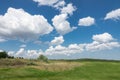 Beautiful landscape. Green grass field and cloudy blue sky Royalty Free Stock Photo