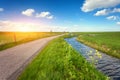 Beautiful landscape with green grass field, road, lighthouse