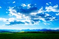 Beautiful landscape, green and yellow meadow and lake with mountain in background. Slovakia, Central Europe. Royalty Free Stock Photo