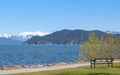 Beautiful landscape of the Harrison Lake and mountains on the background. Empty bench on the beach of the lake Royalty Free Stock Photo