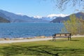 Beautiful landscape of the Harrison Lake and mountains on the background. Empty bench on the beach of the lake. Royalty Free Stock Photo