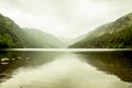 Beautiful landscape from the heart of Glendalough valley in a foggy day, with mountains reflecting in the Lower lake, Ireland. Royalty Free Stock Photo