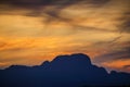 Beautiful landscape with high mountains with illuminated peaks, stones in mountain lake, Royalty Free Stock Photo