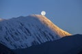 Beautiful landscape in Himalayas, Annapurna  , Nepal. Full moon during a sunrise on the background of snow-capped mountains Royalty Free Stock Photo