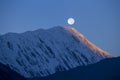 Beautiful landscape in Himalayas, Annapurna, Nepal. Full moon during a sunrise on the background of snow-capped mountains Royalty Free Stock Photo