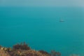 Beautiful landscape with the horizon of the sea and a sailboat in the calm waters of the sea in the afternoon. Royalty Free Stock Photo