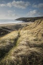 Beautiful landscape image of Freshwater West beach with sand dun