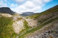 Landscape of the Khibiny mountains with bushes, trees and a mountain peaks on a sunny day. Kola Peninsula, Russia