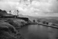 Beautiful landscape in Maharashtra, India with clouds and lake on top of a mountain trek, depicting the peace of nature