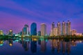 Modern highrises reflecting in lake waters at sunset. Bangkok, Thailand. Beautiful landscape, residential area. Royalty Free Stock Photo