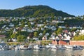 Beautiful landscape with mountain, colorful houses and marina with motorboats in Bergen, Norway Royalty Free Stock Photo