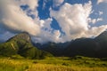 Beautiful landscape mountain green field grass meadow white cloud blue sky on sunny day. Majestic green scenery big mountain hill Royalty Free Stock Photo