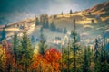 Beautiful landscape mountain hill meadow sunrise foggy morning village Bucovina Romania Royalty Free Stock Photo