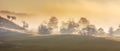 Beautiful landscape mountain hill meadow sunrise foggy morning village Bucovina Romania Royalty Free Stock Photo