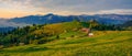 Beautiful landscape mountain hill meadow sunrise morning village Bucovina Romania Royalty Free Stock Photo