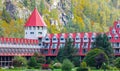 Beautiful landscape of a mountain and lake with red buildings on a shore. Three Valley Gap Lake Chateau Hotel BC, Canada