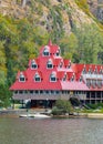 Beautiful landscape of a mountain and lake with red buildings on a shore. Three Valley Gap Lake Chateau Hotel BC, Canada