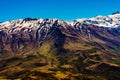 beautiful landscape of the mountain slopes with spring vegetation of the chilean andes with snow