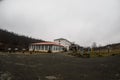 Beautiful landscape of mountains and forest with village building or old abandoned ruined brick house. Foggy forest and old buildi