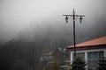 Beautiful landscape of mountains and forest with village building or old abandoned ruined brick house. Foggy forest and old buildi