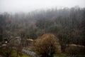 Beautiful landscape of mountains and forest with village building or old abandoned ruined brick house. Foggy forest and old buildi