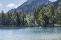 Beautiful landscape of mountains and lake and people kayaking Royalty Free Stock Photo