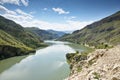 Beautiful landscape with mountains and a river on a sunny summer day with clouds Royalty Free Stock Photo