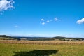 Beautiful landscape in the North Eifel in Germany, with a rye field in the foreground.